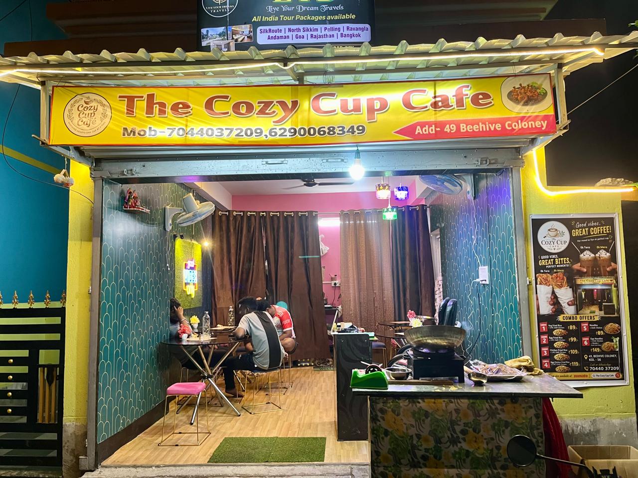 The Cozy Cup Cafe storefront at night